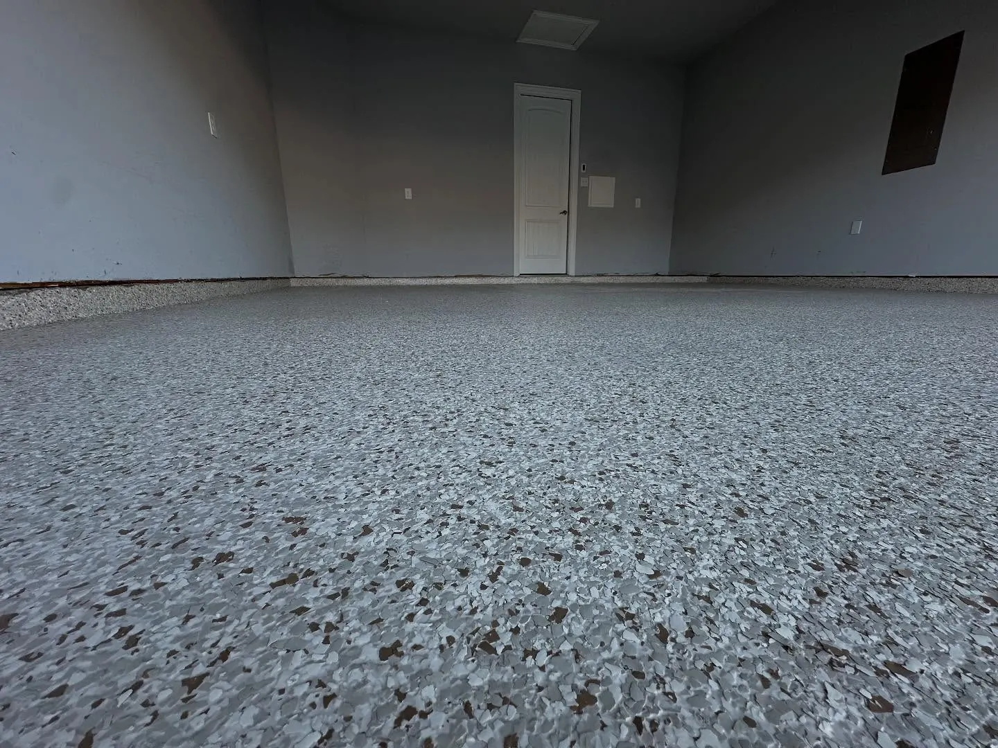 Finished full-flake epoxy garage floor coating in an Arlington, TX home
