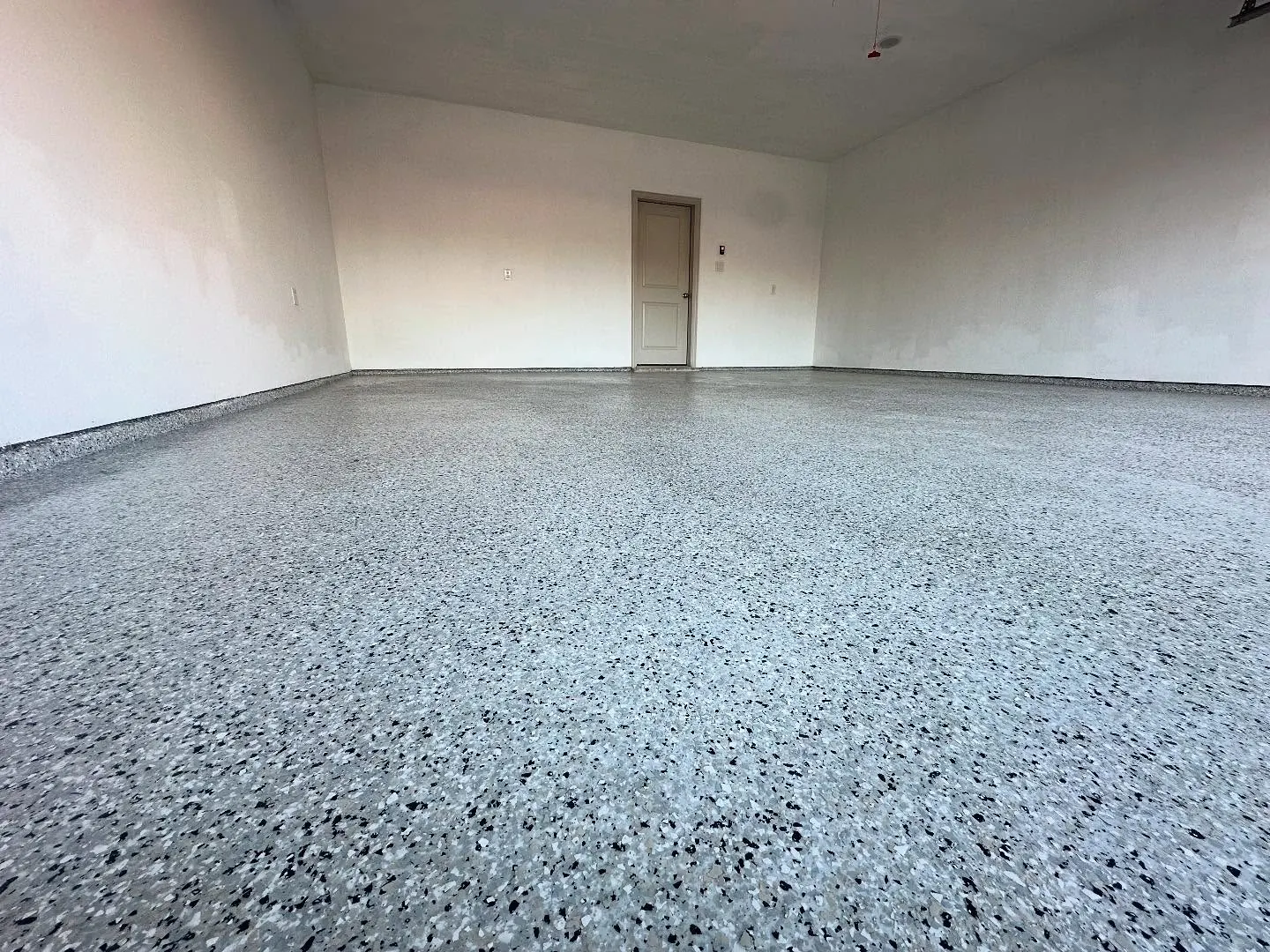 Light flake polyaspartic garage floor coating in Fort Worth, TX, a Flooring Contractor Arlington project